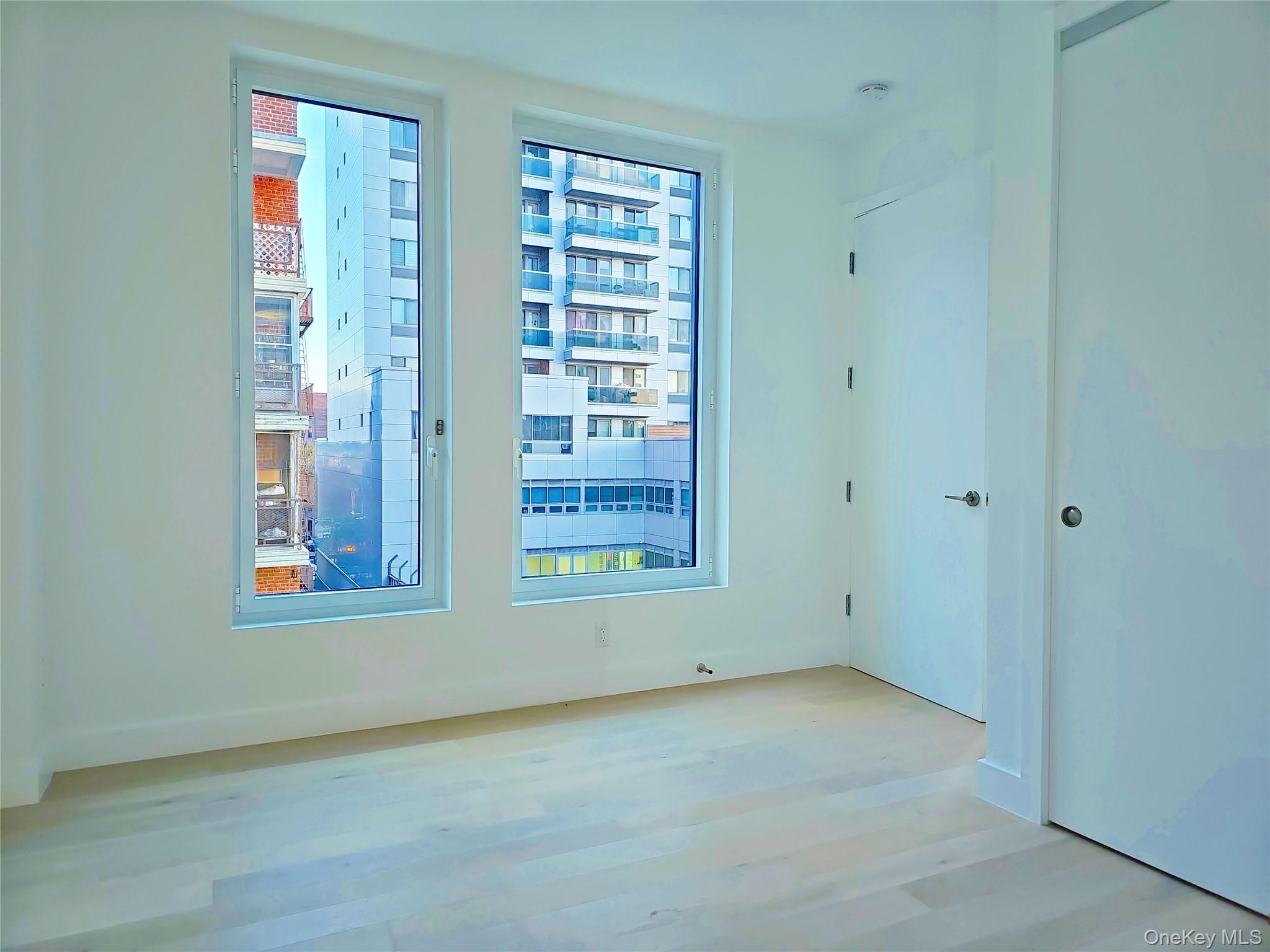 136-18 Maple Avenue, Unit 5B Queens, NY 11355 - Photo 29 of 31 a view of an empty room with a window