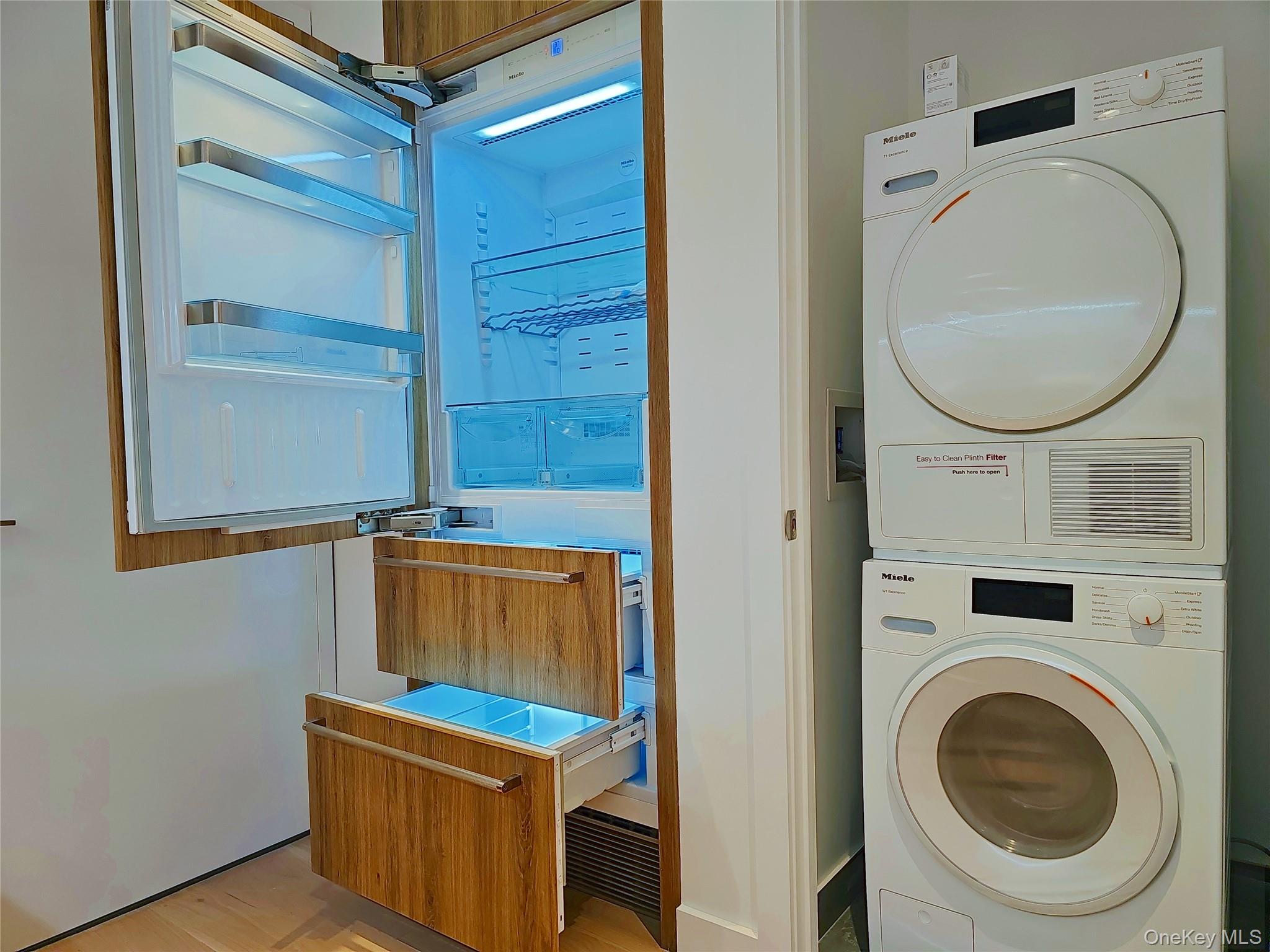 136-18 Maple Avenue, Unit 5B Queens, NY 11355 - Photo 31 of 31 a utility room with dryer and washer