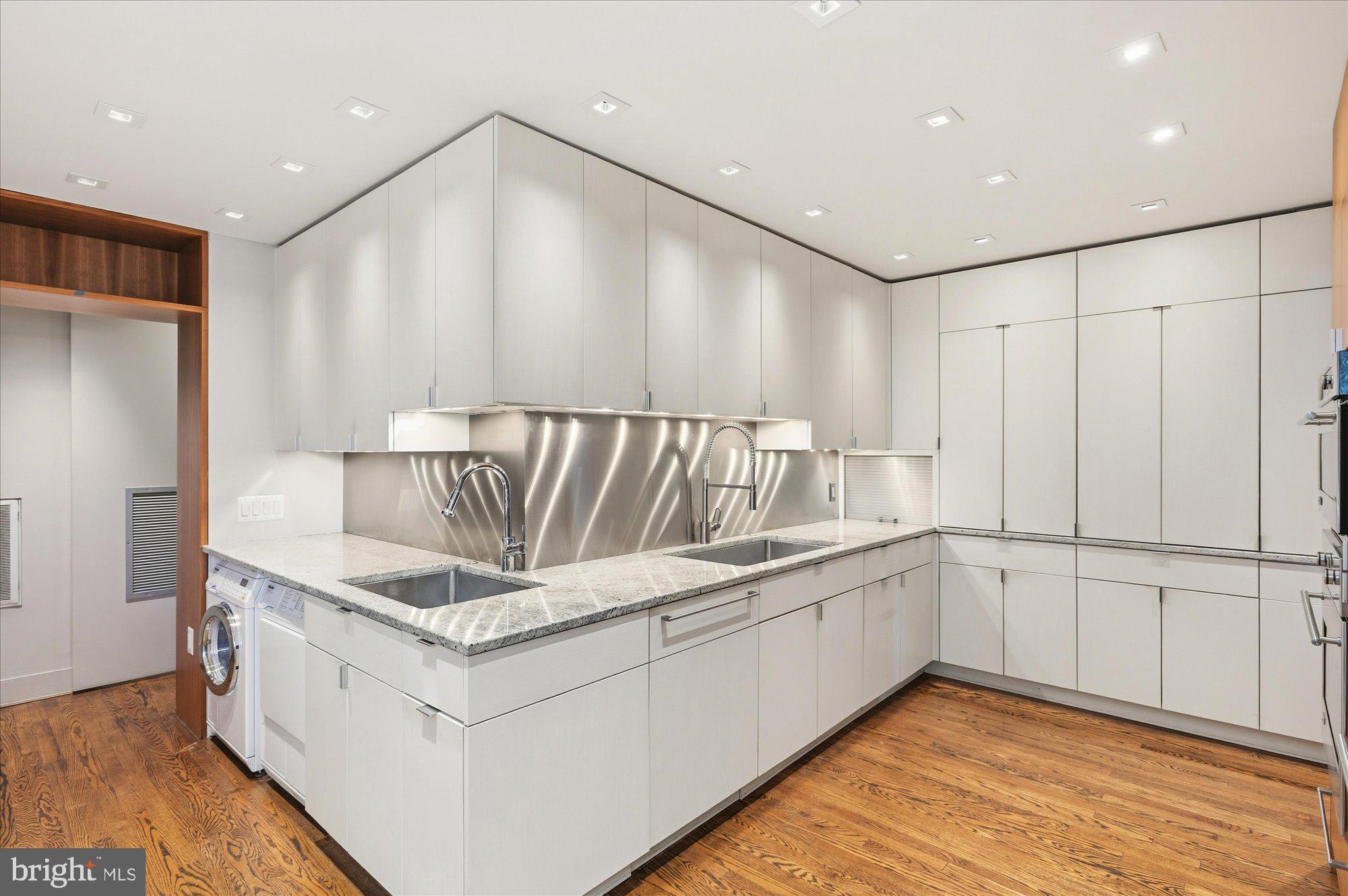 2101 Connecticut Avenue Northwest, Unit 53 Washington, DC 20009 - Photo 15 of 45 a kitchen with a refrigerator and white cabinets