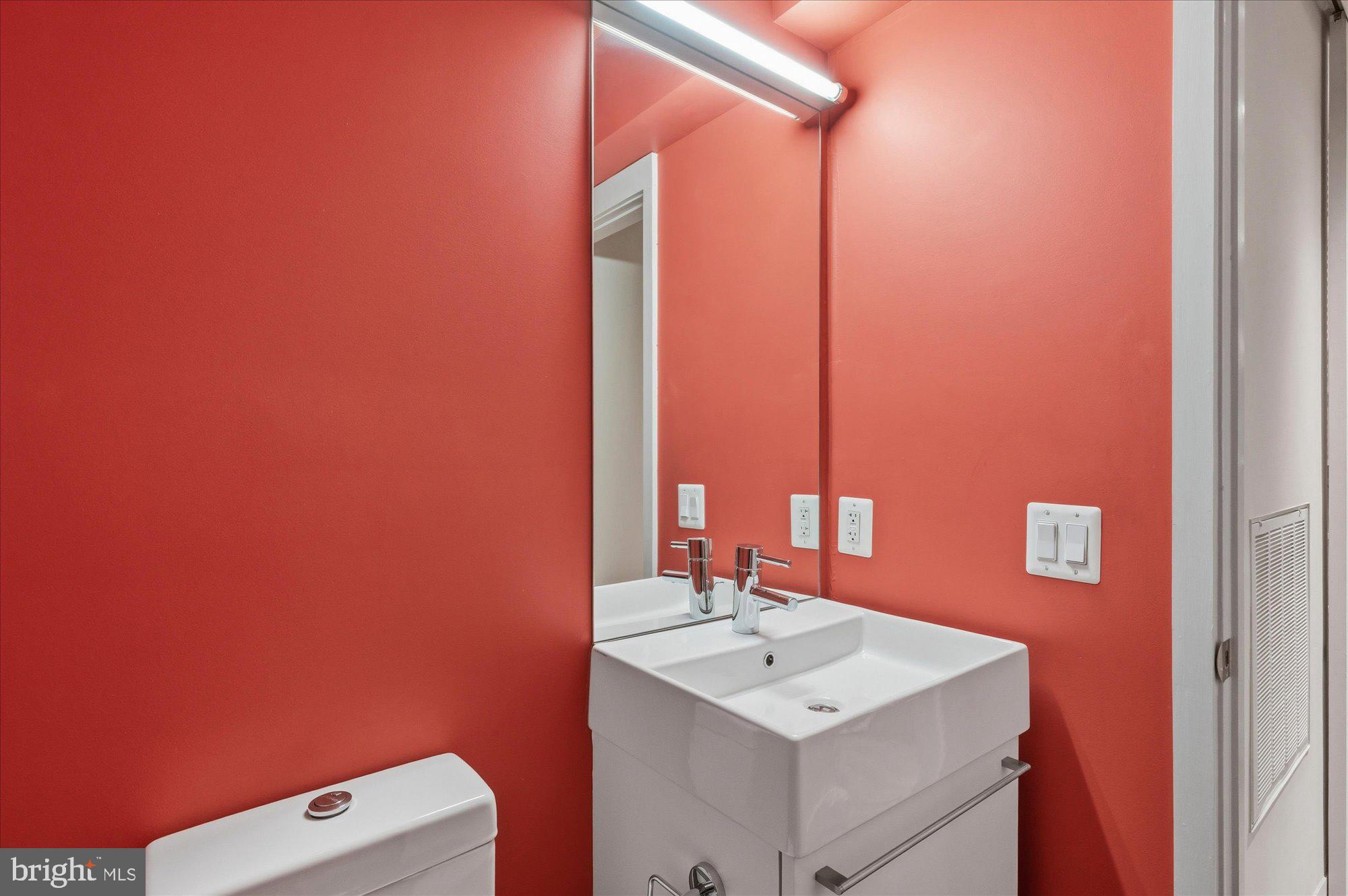 2101 Connecticut Avenue Northwest, Unit 53 Washington, DC 20009 - Photo 19 of 45 a bathroom with a sink a toilet and mirror