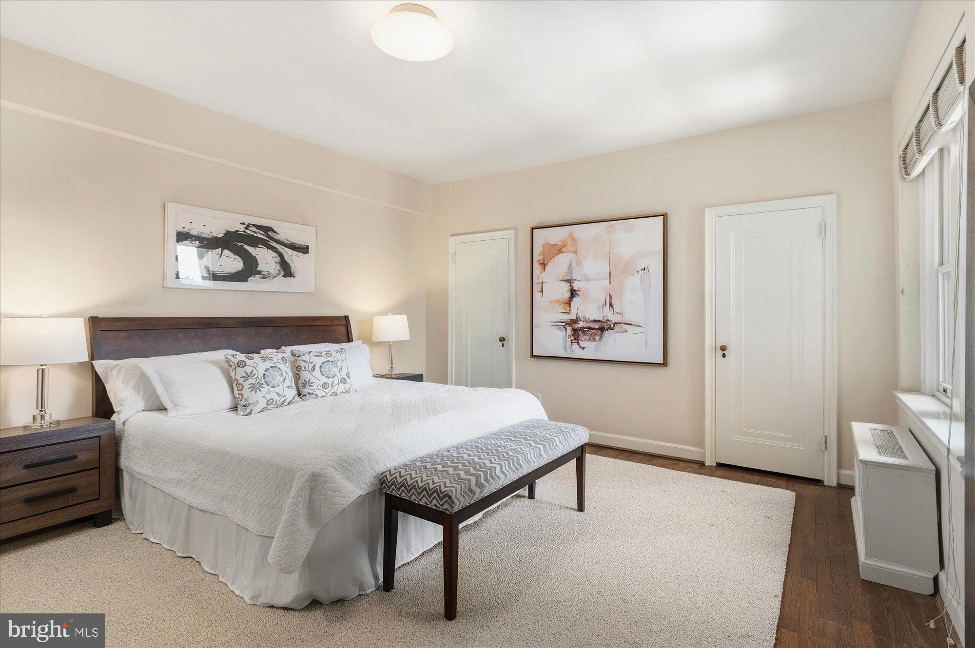 2101 Connecticut Avenue Northwest, Unit 53 Washington, DC 20009 - Photo 22 of 45 a bedroom with a bed and a painting on the wall