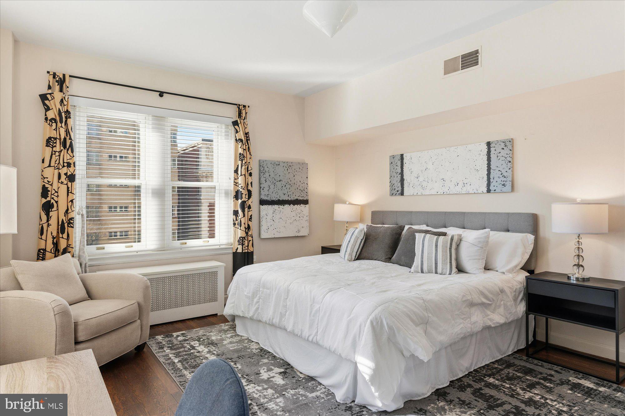 2101 Connecticut Avenue Northwest, Unit 53 Washington, DC 20009 - Photo 24 of 45 a bedroom with a bed couch and a large window