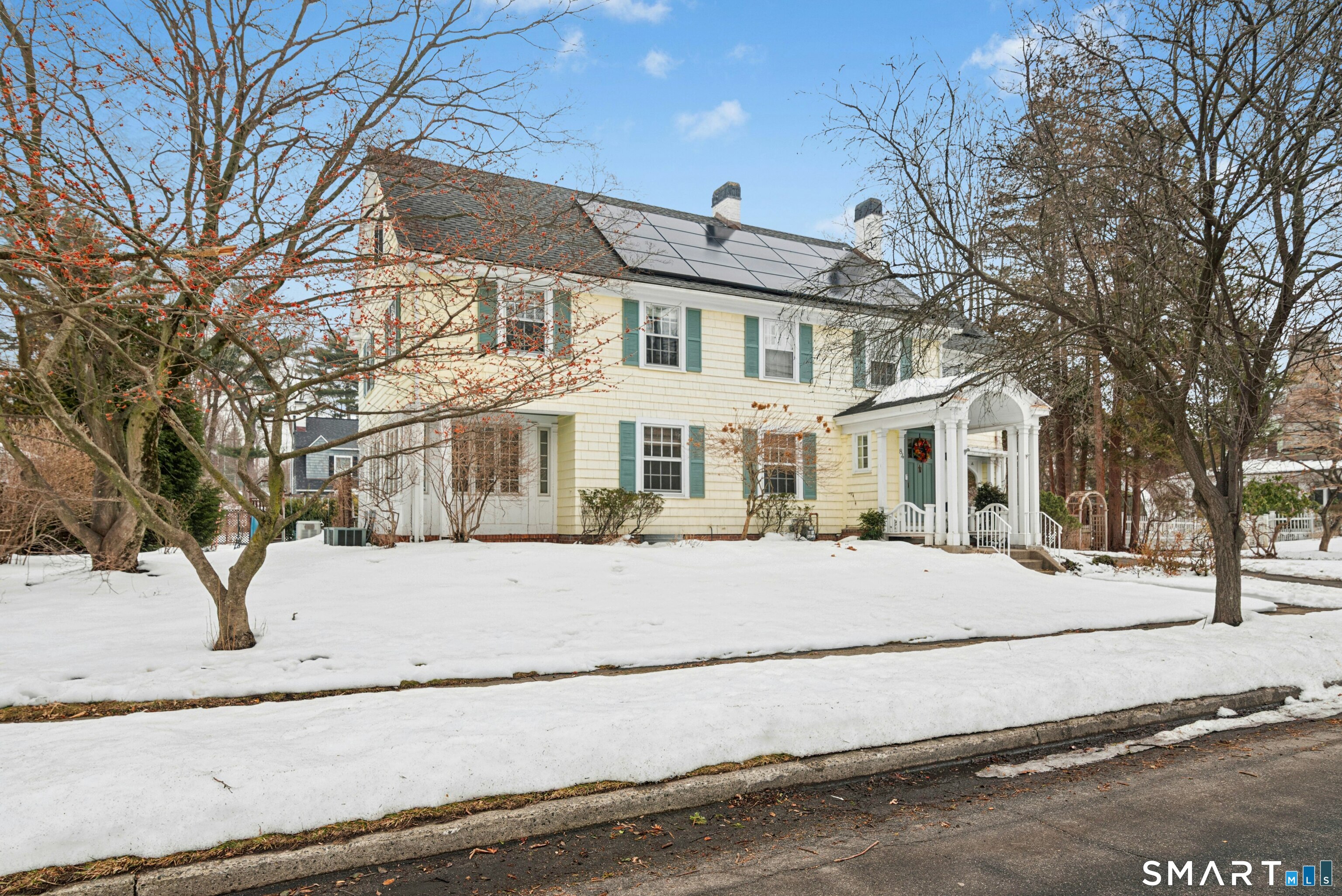 84 Algonquin Road Fairfield, CT 06825 - Photo 1 of 28 a front view of a house with a snow on the road