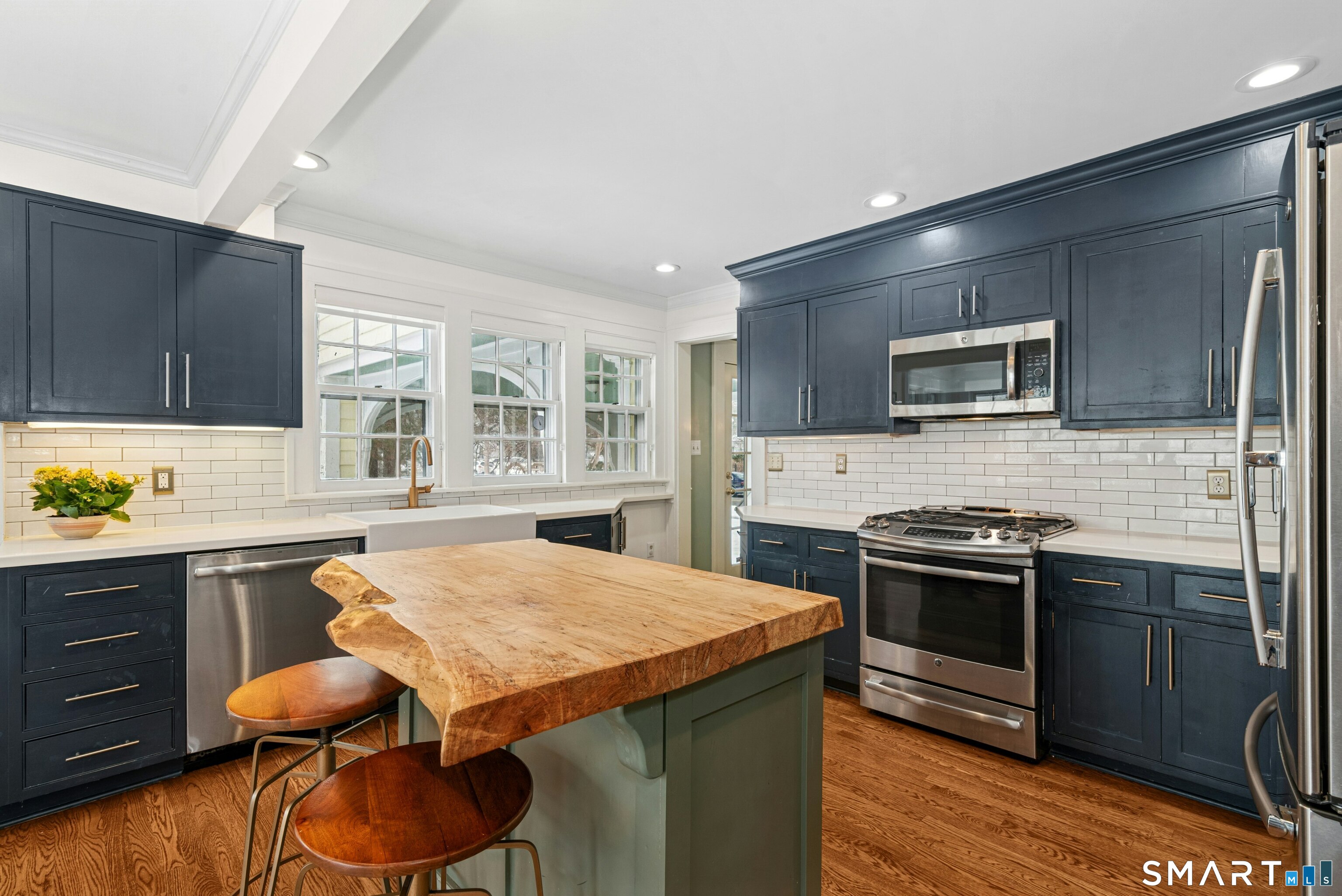 84 Algonquin Road Fairfield, CT 06825 - Photo 11 of 28 a kitchen with stainless steel appliances a stove sink microwave and cabinets
