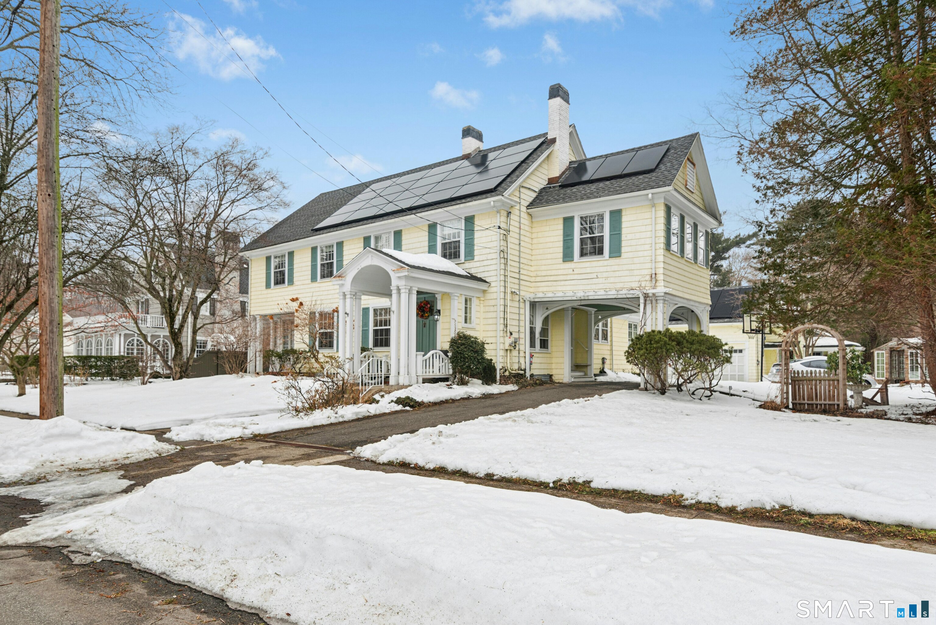 84 Algonquin Road Fairfield, CT 06825 - Photo 2 of 28 a view of a white house with a large tree in front of it