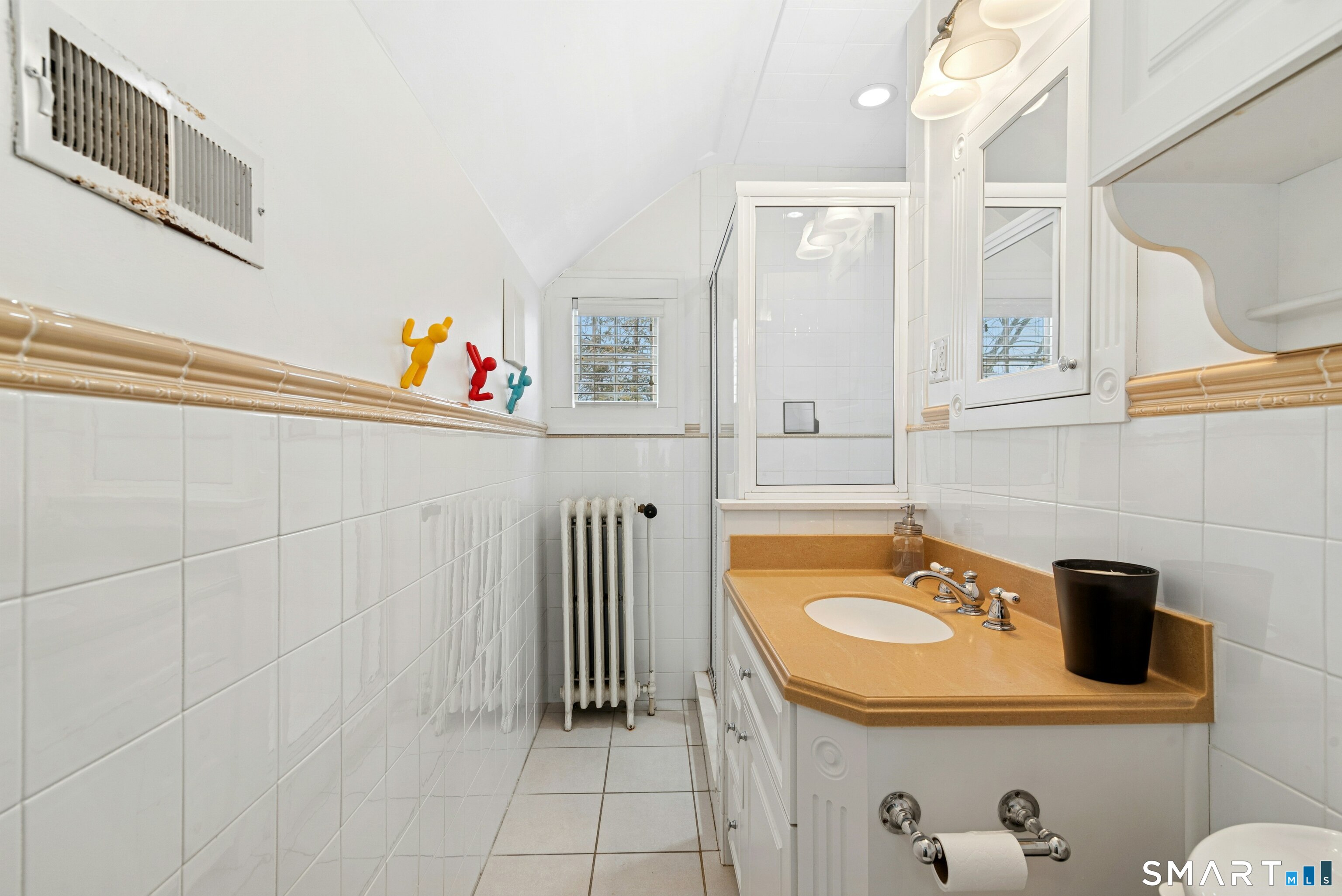 84 Algonquin Road Fairfield, CT 06825 - Photo 25 of 28 a bathroom with a sink a mirror and a shower