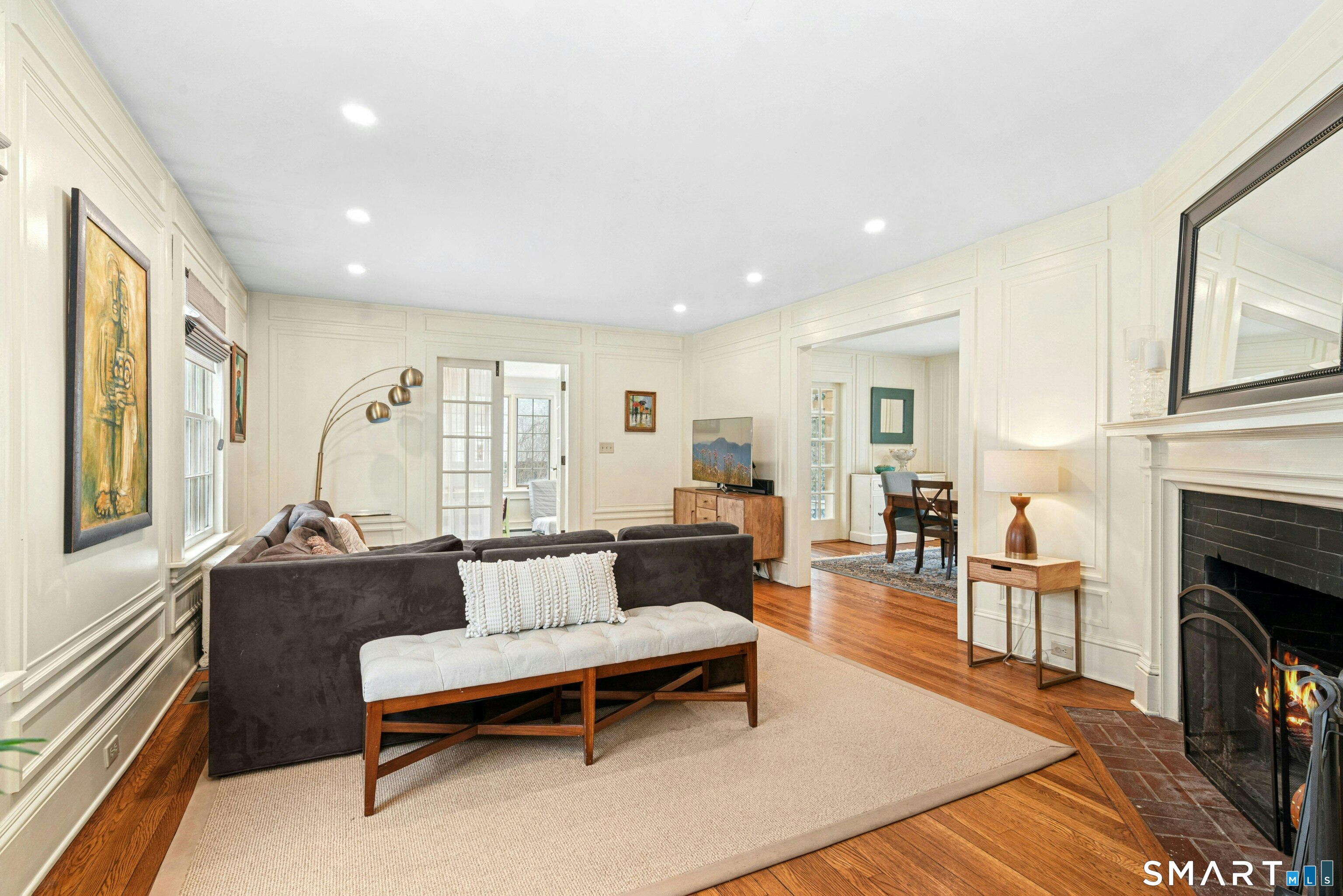 84 Algonquin Road Fairfield, CT 06825 - Photo 5 of 28 a living room with furniture a fireplace and a table