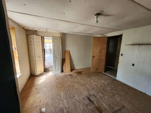 a view of a livingroom with wooden floor and a window