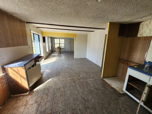 a kitchen with a sink stove and refrigerator
