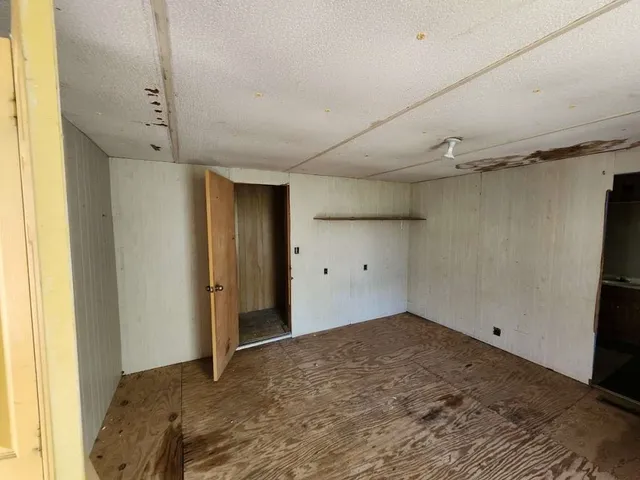 a view of a hallway with furniture and a window