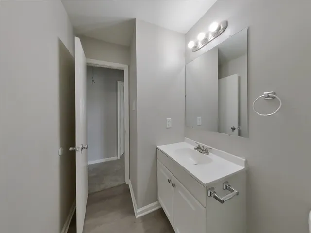 a bathroom with a sink mirror and vanity