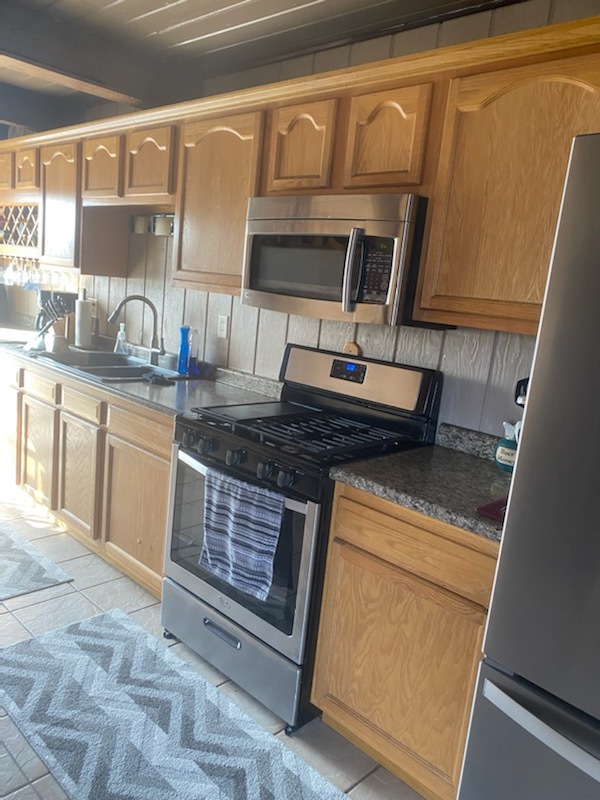 1765 West Mine Road Mazon, IL 60444 - Photo 11 of 21 a kitchen with stainless steel appliances granite countertop a sink stove and cabinets