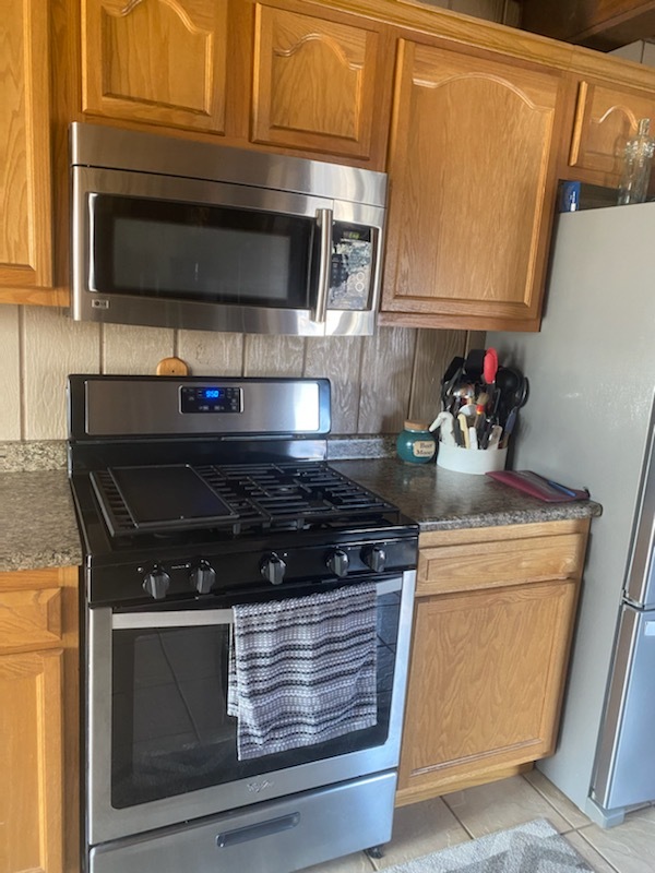 1765 West Mine Road Mazon, IL 60444 - Photo 9 of 21 a kitchen with stainless steel appliances granite countertop a stove and a microwave