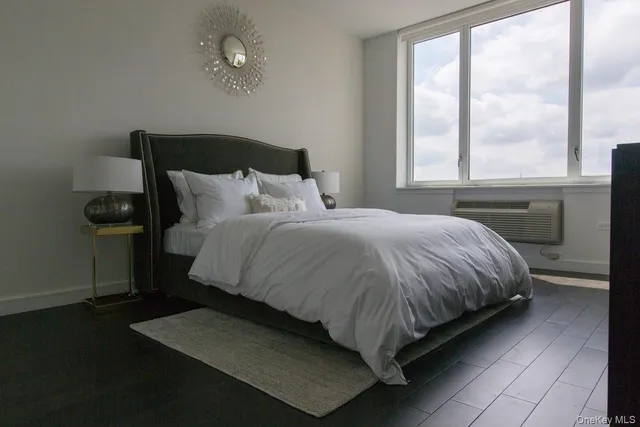 a bed sitting in a bedroom next to a window