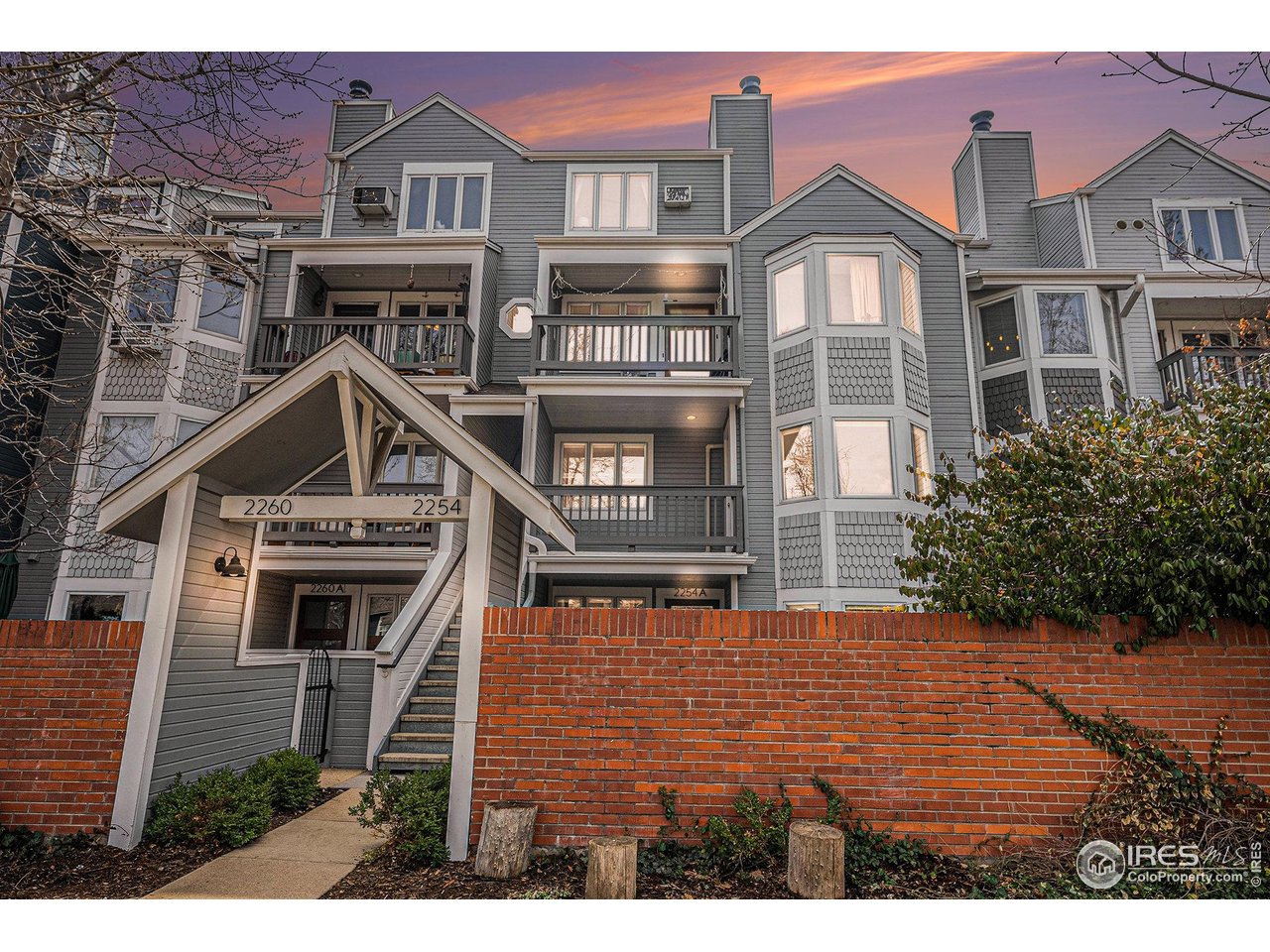 a view of a brick building next to a yard