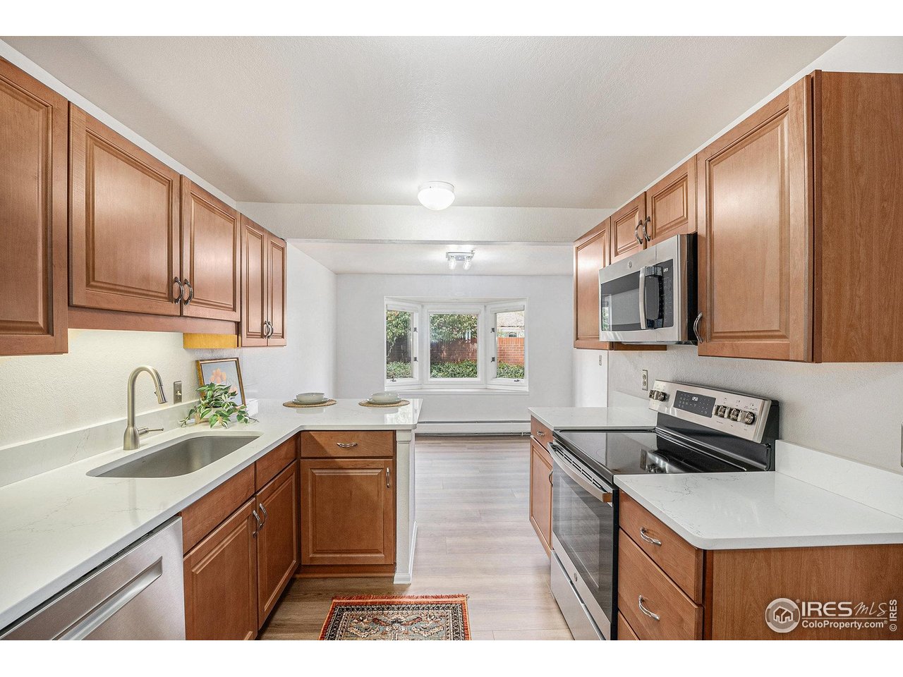 2254 Spruce Street, Unit A Boulder, CO 80302 - Photo 2 of 15 a kitchen with a sink stove top oven and refrigerator