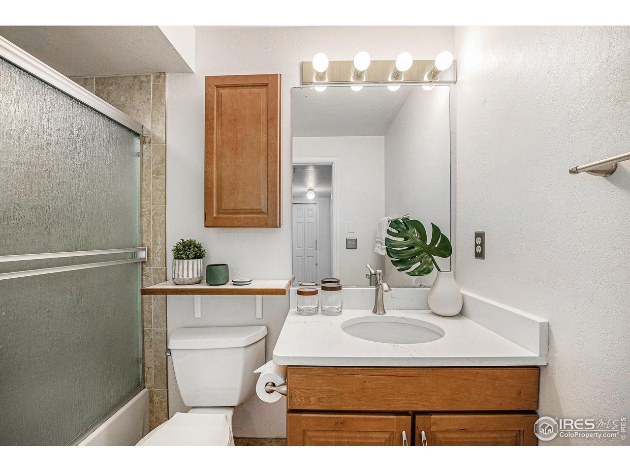 2254 Spruce Street, Unit A Boulder, CO 80302 - Photo 8 of 15 a bathroom with a sink toilet and mirror
