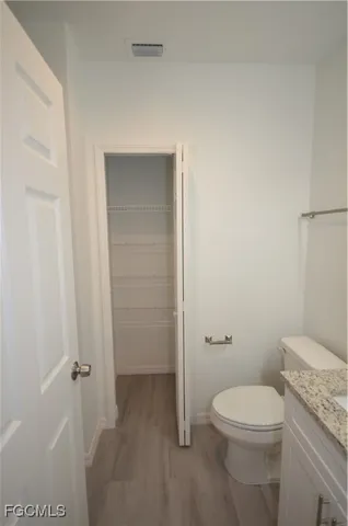 a white toilet sitting next to a bathroom sink