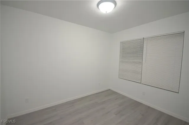 an empty room with wooden floor