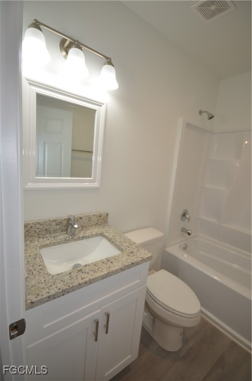 2218 Quality Life Center Way Fort Myers, FL 33916 - Photo 20 of 30 a bathroom with a granite countertop sink toilet and shower