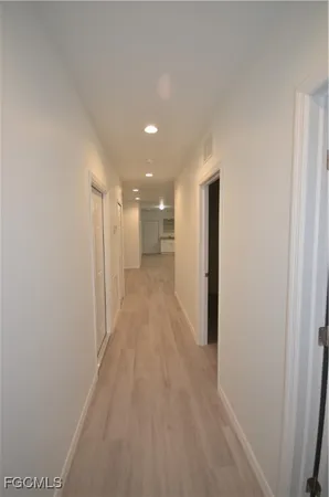 a view of a hallway with wooden floor