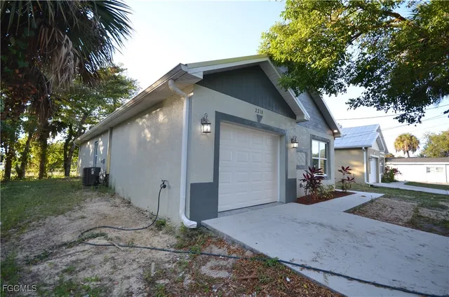 a view of a house with a yard and garage