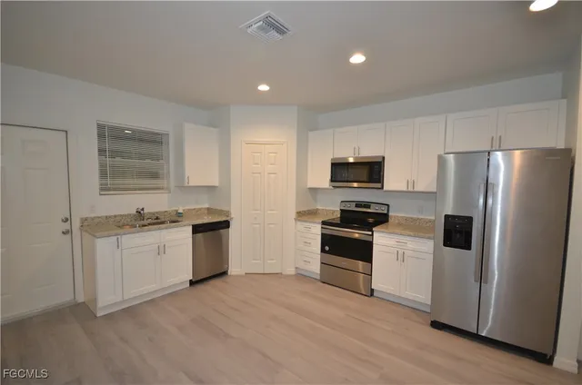 a kitchen with a refrigerator stove and sink