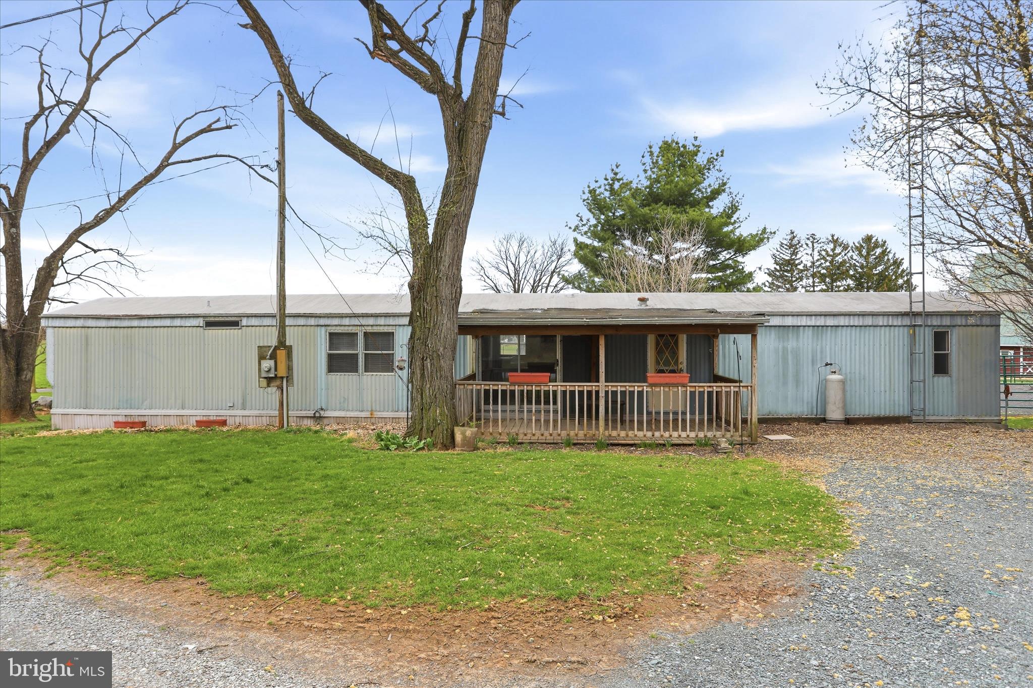 1873 Clay Hill Road Chambersburg, PA 17202 - Photo 1 of 1 a front view of a house with a yard and trees