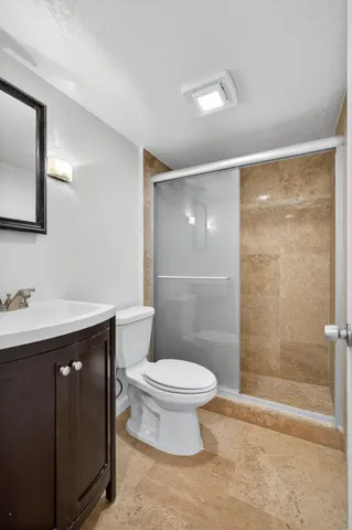 a bathroom with a sink toilet and shower