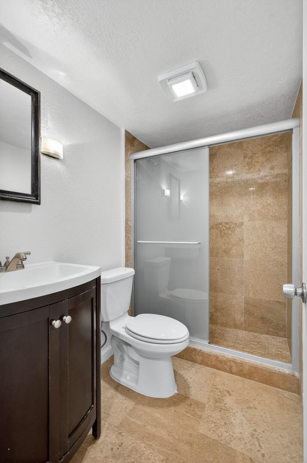5600 North Flagler Drive, Unit 2703 West Palm Beach, FL 33407 - Photo 11 of 60 a bathroom with a sink toilet and shower