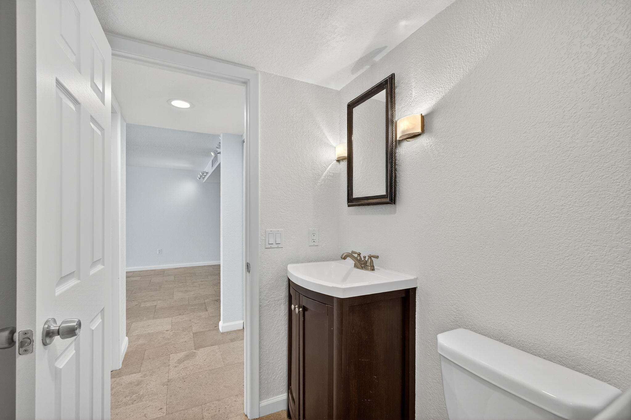 5600 North Flagler Drive, Unit 2703 West Palm Beach, FL 33407 - Photo 12 of 60 a bathroom with a toilet sink and mirror