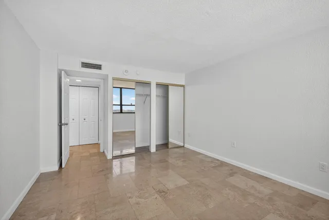 an empty room with sliding glass door