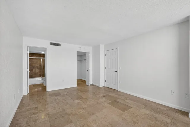 a bathroom with a granite countertop sink a toilet and shower
