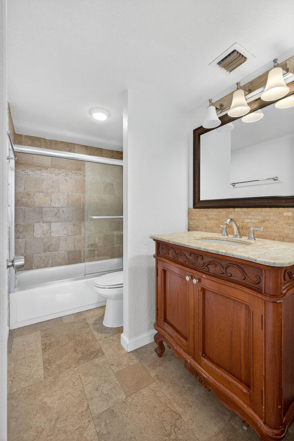 5600 North Flagler Drive, Unit 2703 West Palm Beach, FL 33407 - Photo 20 of 60 a bathroom with a granite countertop sink a toilet and bathtub