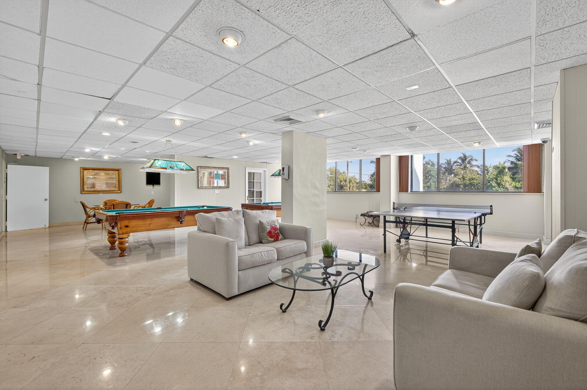 5600 North Flagler Drive, Unit 2703 West Palm Beach, FL 33407 - Photo 38 of 60 a living room with furniture and a table