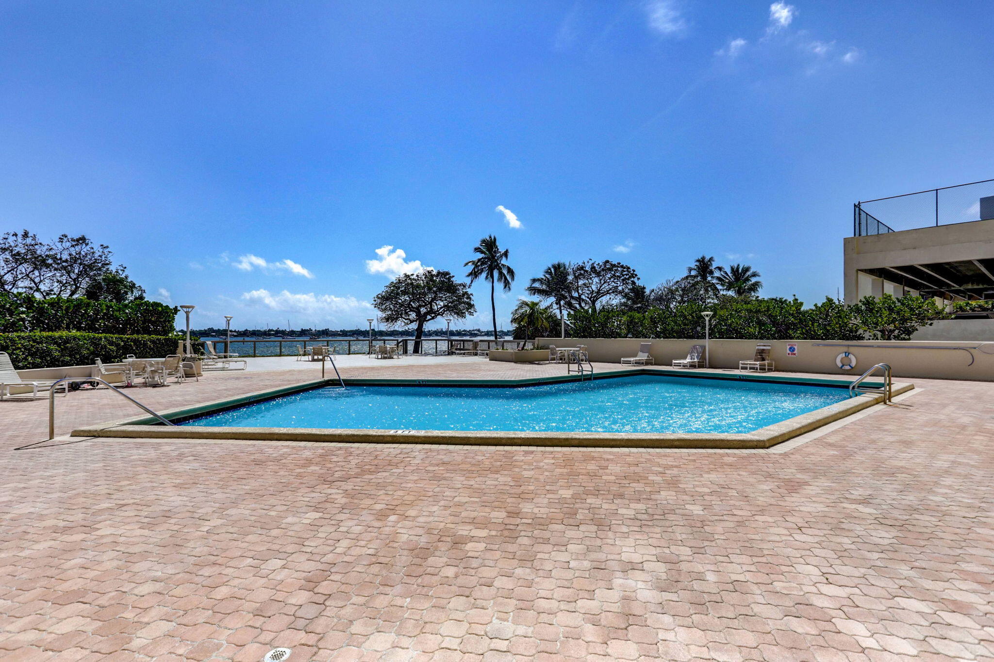 5600 North Flagler Drive, Unit 2703 West Palm Beach, FL 33407 - Photo 42 of 60 a view of a swimming pool with a yard