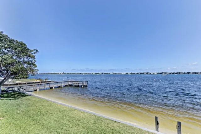 an aerial view of a house with a yard and lake view