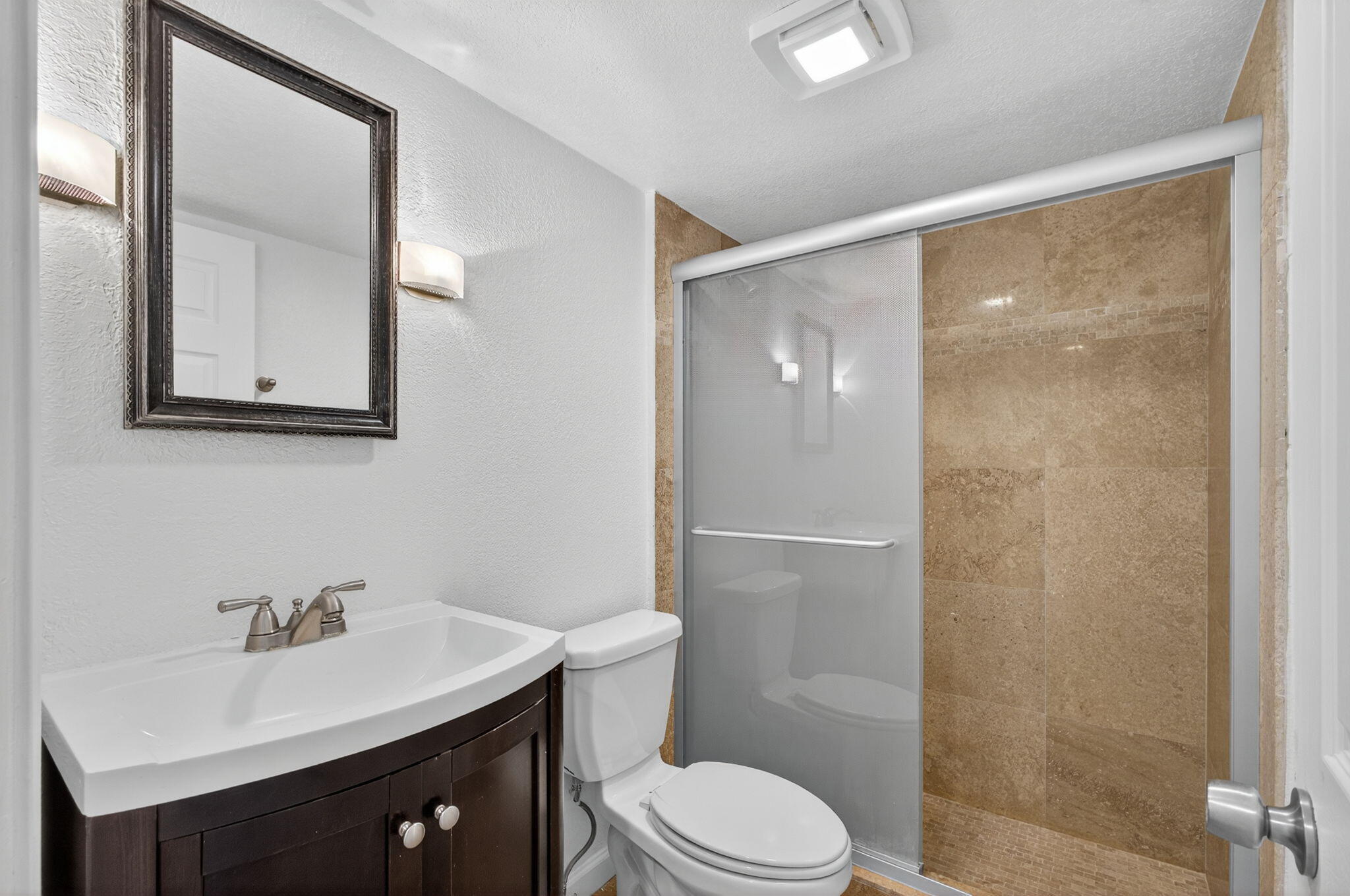 5600 North Flagler Drive, Unit 2703 West Palm Beach, FL 33407 - Photo 10 of 60 a bathroom with a sink a toilet and shower