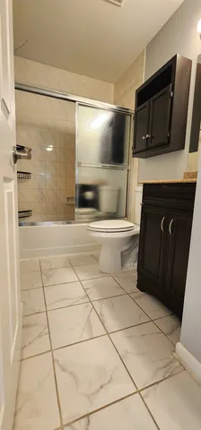 a bathroom with a sink a toilet and mirror