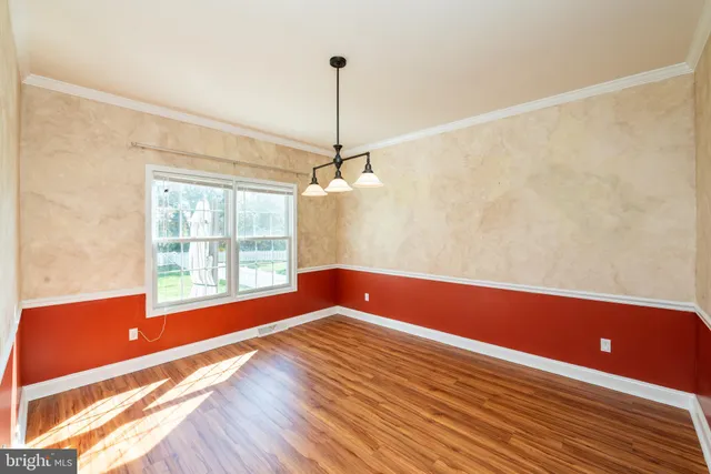 a view of room with window and wooden floor