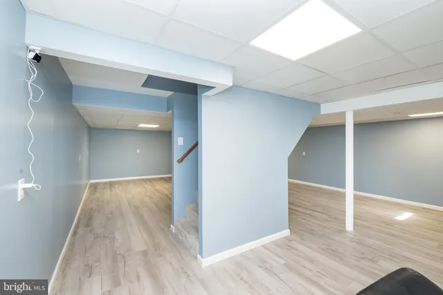 a view of hallway with wooden floor