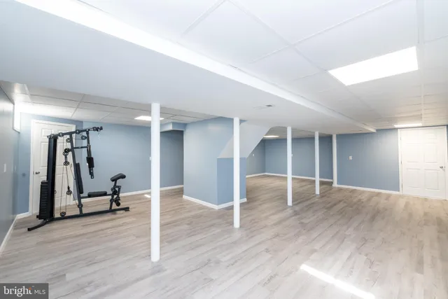a view of a hallway with wooden floor and furniture