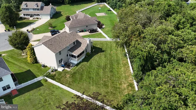 an aerial view of a house with a garden and trees