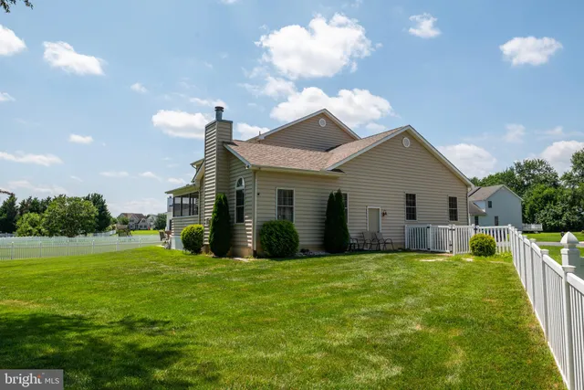 a view of a house with a yard and porch