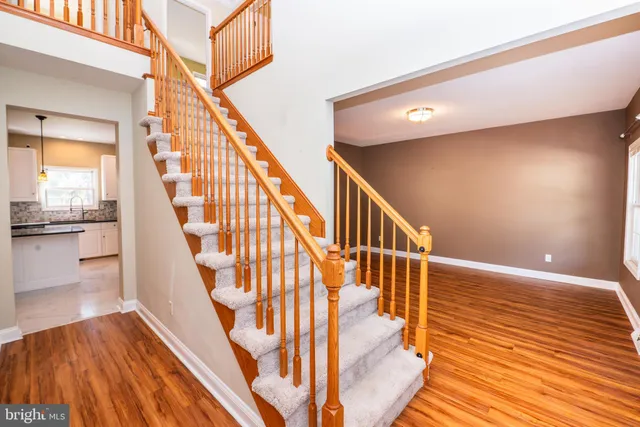 a view of entryway and hall with wooden floor