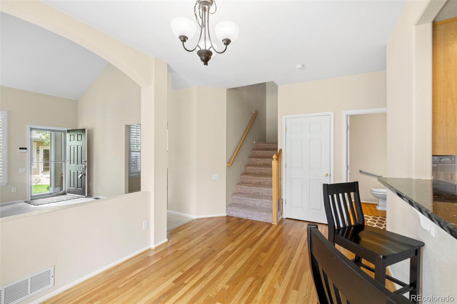 6228 Trailhead Road Highlands Ranch, CO 80130 - Photo 8 of 25 a view of a room with wooden floor and staircase