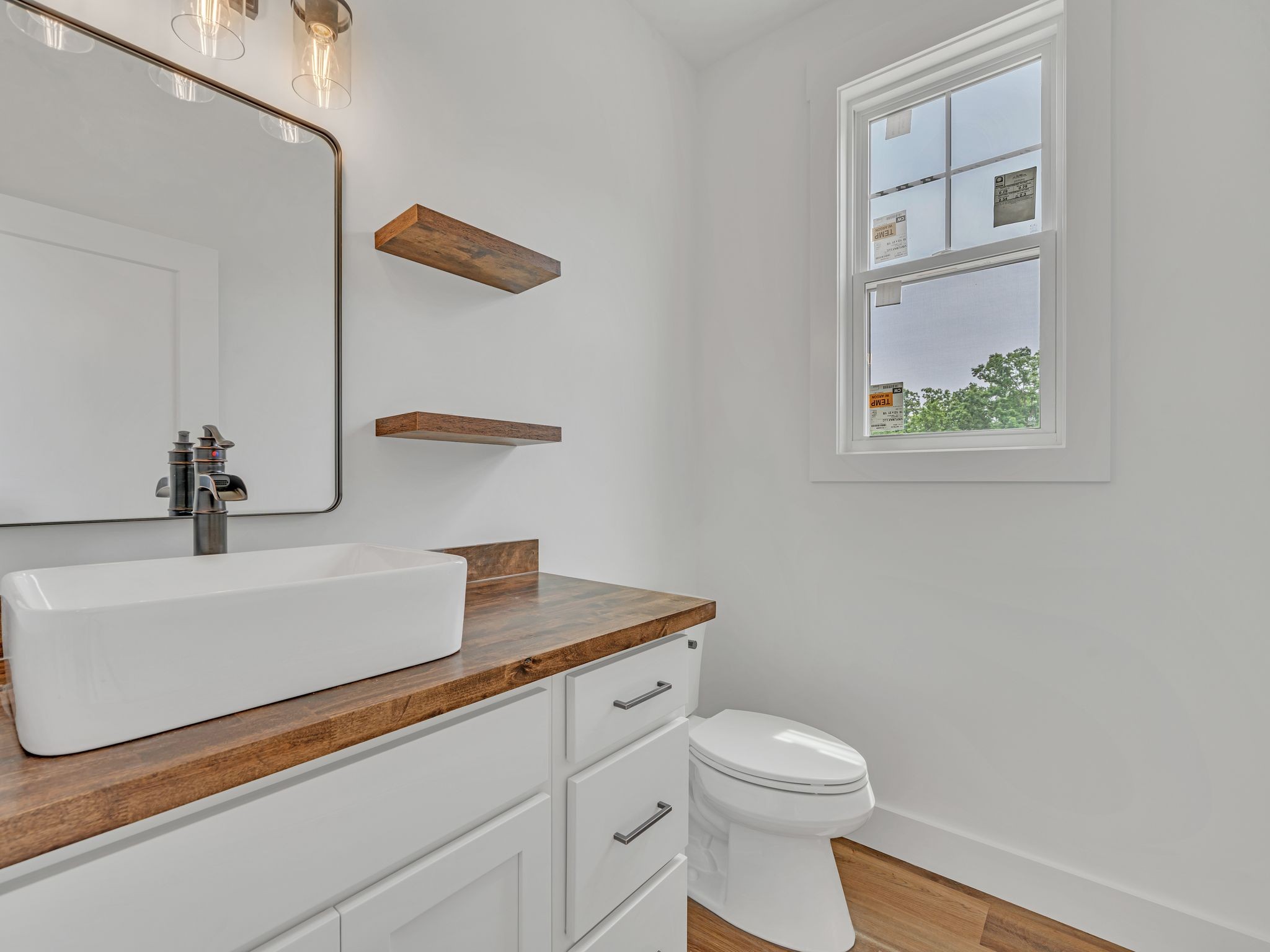 5800 Sanders Road Lyles, TN 37098 - Photo 14 of 28 a bathroom with a toilet a sink and mirror