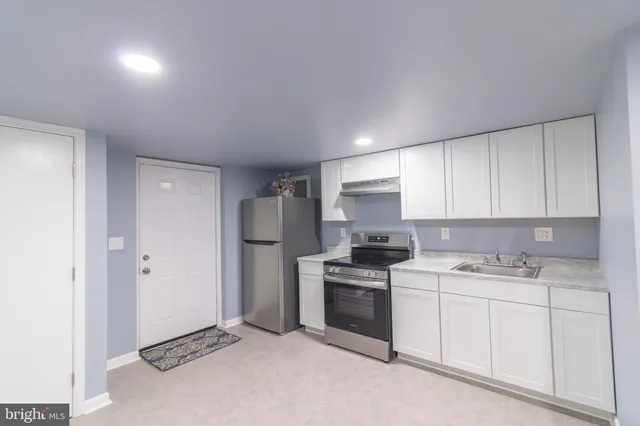 a kitchen with a sink stove and refrigerator