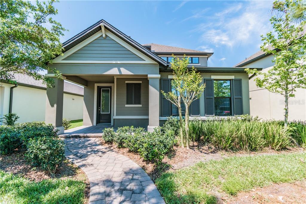 3049 Riders Pass Odessa, FL 33556 - Photo 1 of 1 a front view of a house with garden