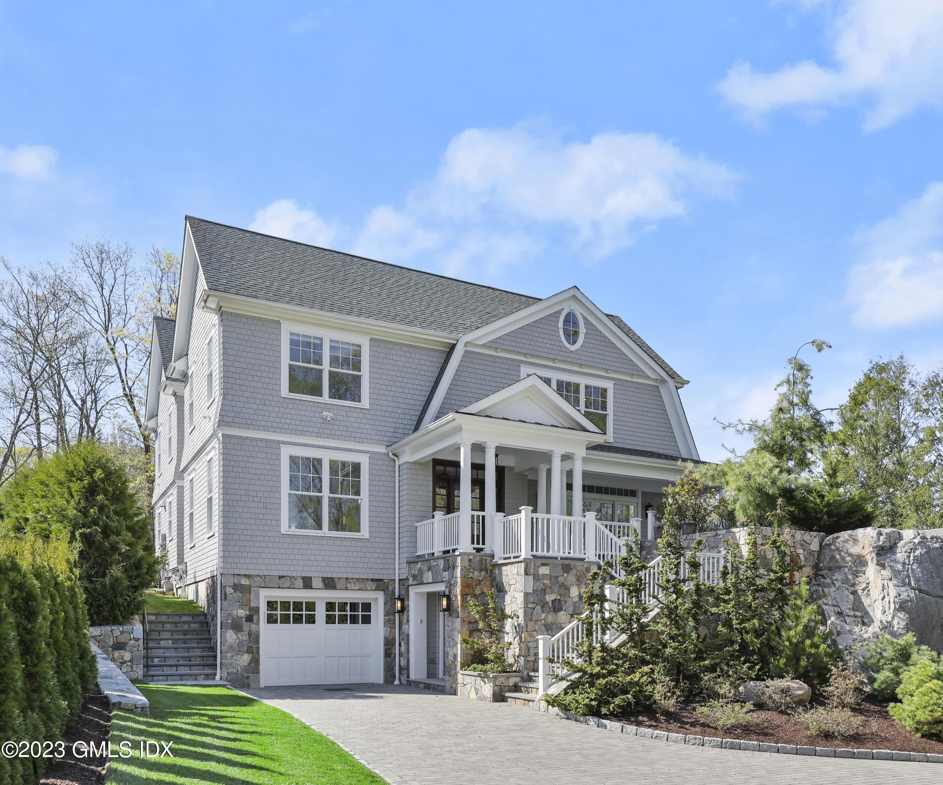 196 Valley Road Cos Cob, CT 06807 - Photo 1 of 18 a front view of a house with a garden and plants